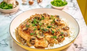 Easy Chicken Marsala Chicken Marsala in skillet with creamy sauce.
