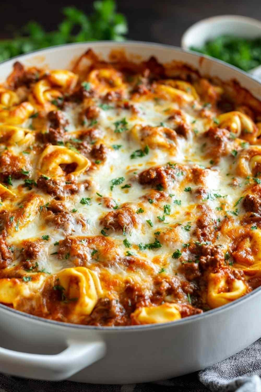 Beefy tortellini bake in baking dish with golden melted cheese on top fresh from oven