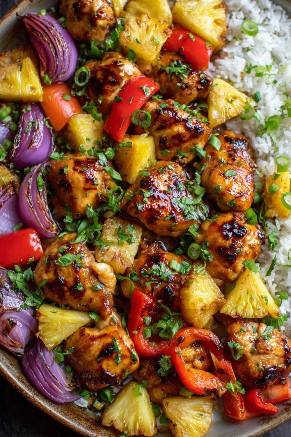 Hawaiian chicken sheet pan with caramelized pineapple and colorful bell peppers on white serving platter