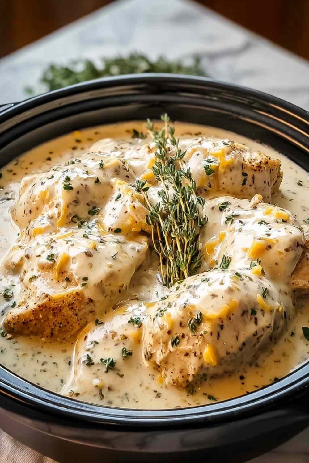 Creamy ranch chicken crockpot with tender shredded chicken in rich ranch sauce garnished with fresh parsley