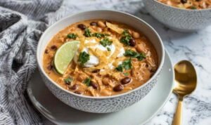 Creamy white chicken chili with beans and corn in a large pot ready to serve