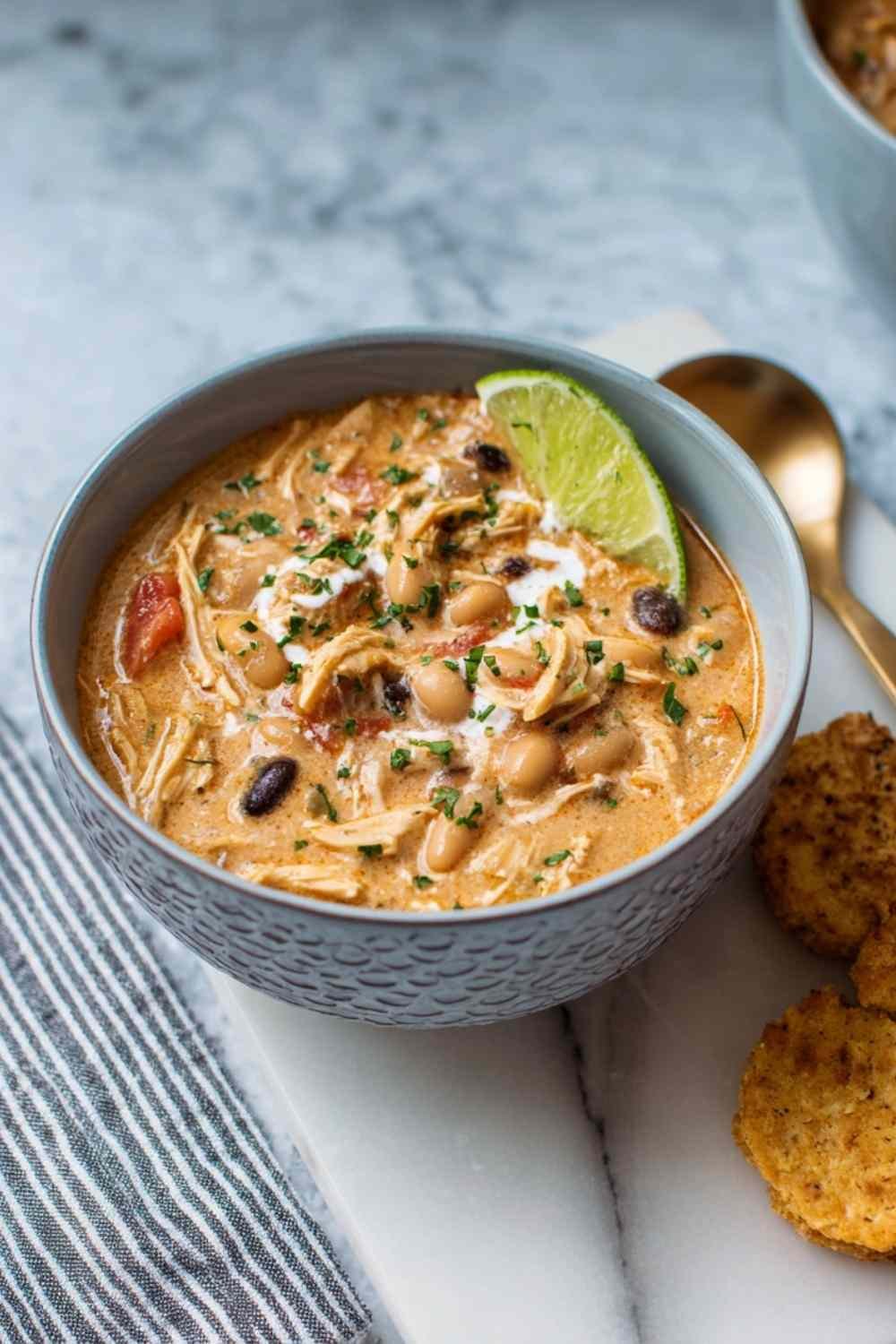 Creamy white chicken chili with beans and corn in a large pot ready to serve