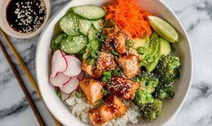 Crispy Salmon Bowls Crispy salmon bowls with glazed salmon, avocado, cucumbers, and sushi rice topped with sesame seeds
