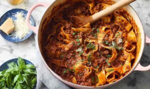 Dutch Oven Short Rib Ragu with Pappardelle Dutch oven short rib ragu served over pappardelle pasta with grated parmesan cheese