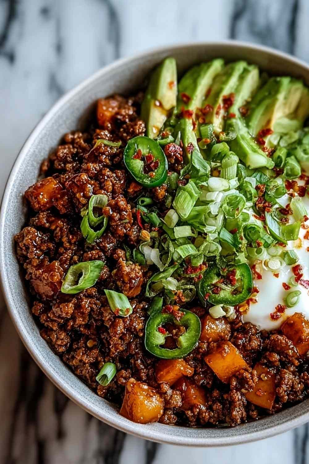 Ground Beef Hot Honey Bowl with roasted sweet potatoes cottage cheese and avocado slices drizzled with hot honey