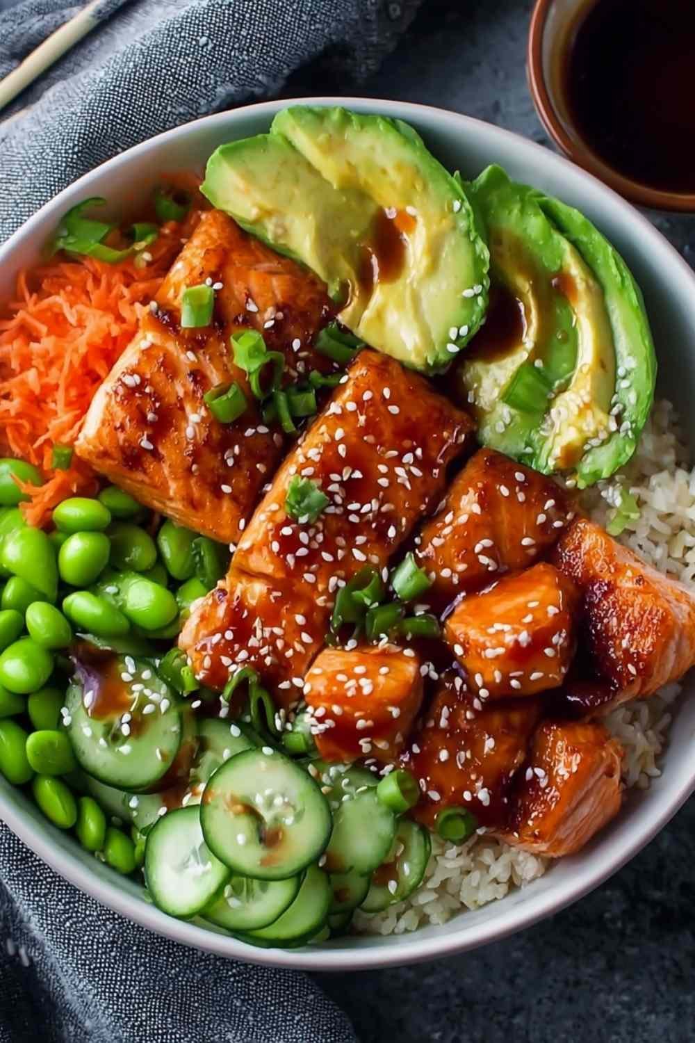 Honey sriracha salmon bowls with glazed salmon cubes, avocado, cucumber and edamame over white rice