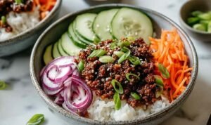 Korean Ground Beef Bowl Korean Ground Beef Bowl with rice topped with sesame seeds and green onions in white bowl