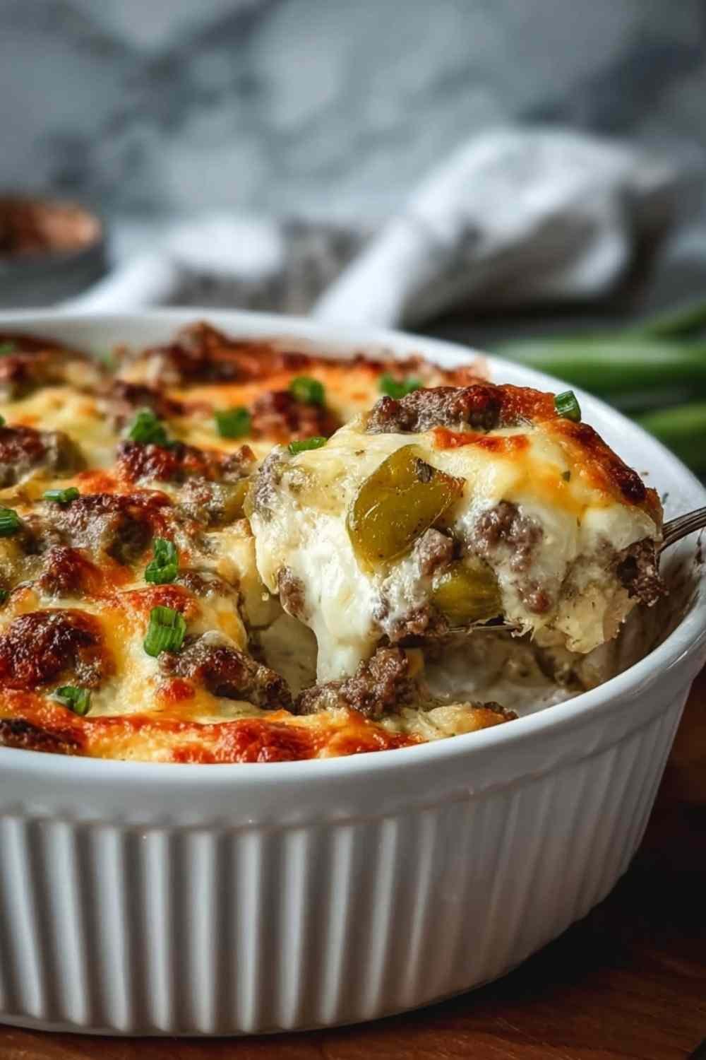 Low carb philly cheesesteak casserole with melted cheese in 9x13 baking dish