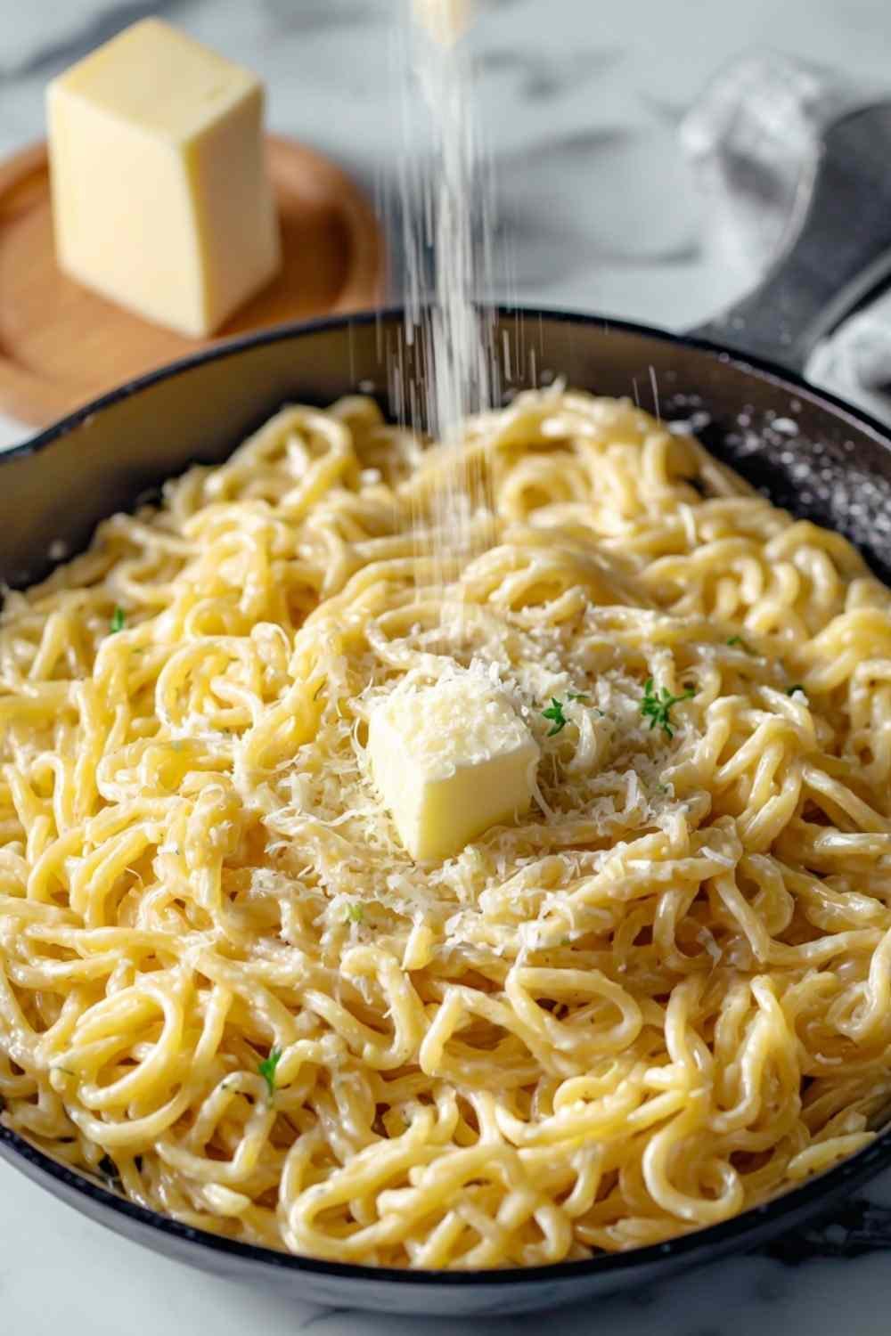 Creamy one-pan butter parmesan pasta in large skillet with melted cheese and fresh parsley garnish