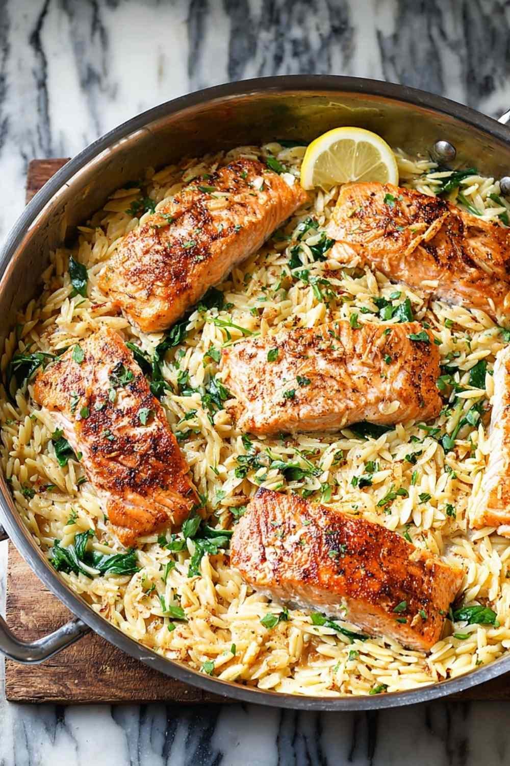 One skillet salmon with lemon orzo featuring pan-seared salmon fillets over creamy Parmesan orzo with spinach