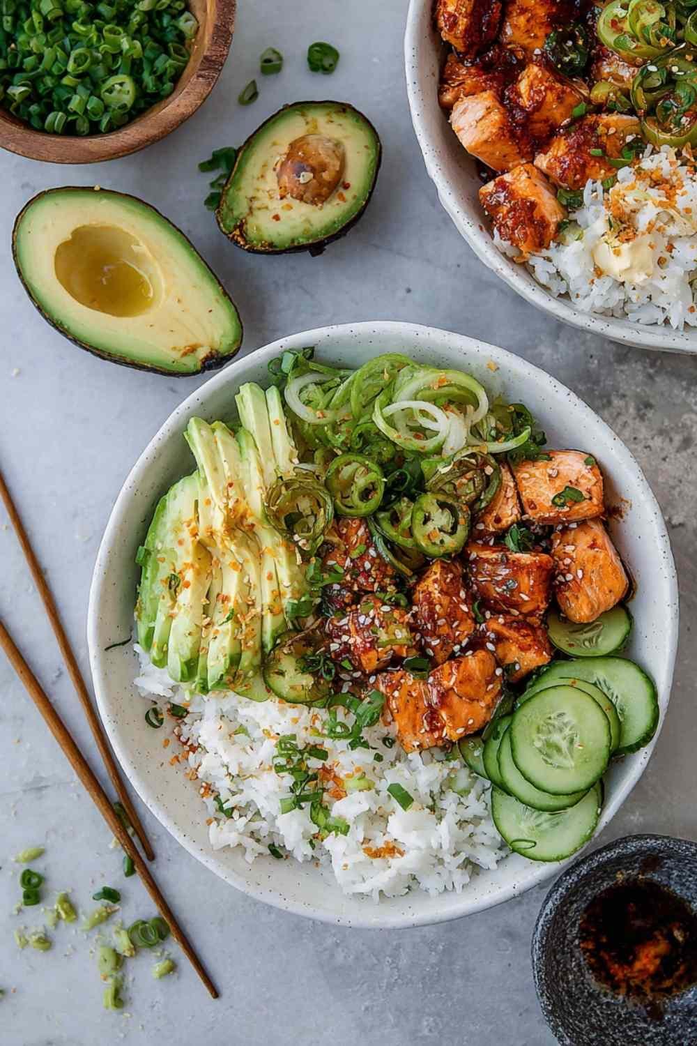 Honey glazed salmon bowls with crispy caramelized salmon, brown rice, cucumber avocado salad, and paprika mayo drizzle