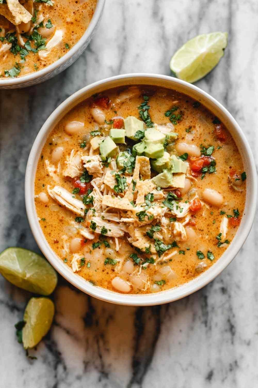 white chicken chili recipe in dutch oven with shredded chicken and white beans