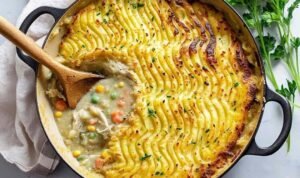 Chicken Shepherd's Pie Chicken shepherd's pie with golden mashed potato topping in white serving bowl