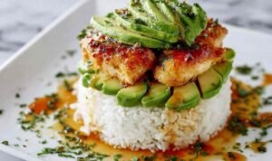 Honey lime chicken avocado rice stack plated with grilled chicken slices on jasmine rice topped with fresh avocado