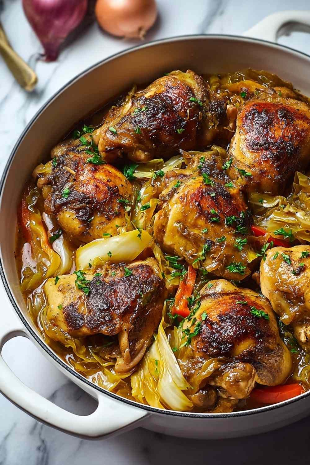 Jamaican chicken and cabbage cooking in a skillet with colorful vegetables and Caribbean spices