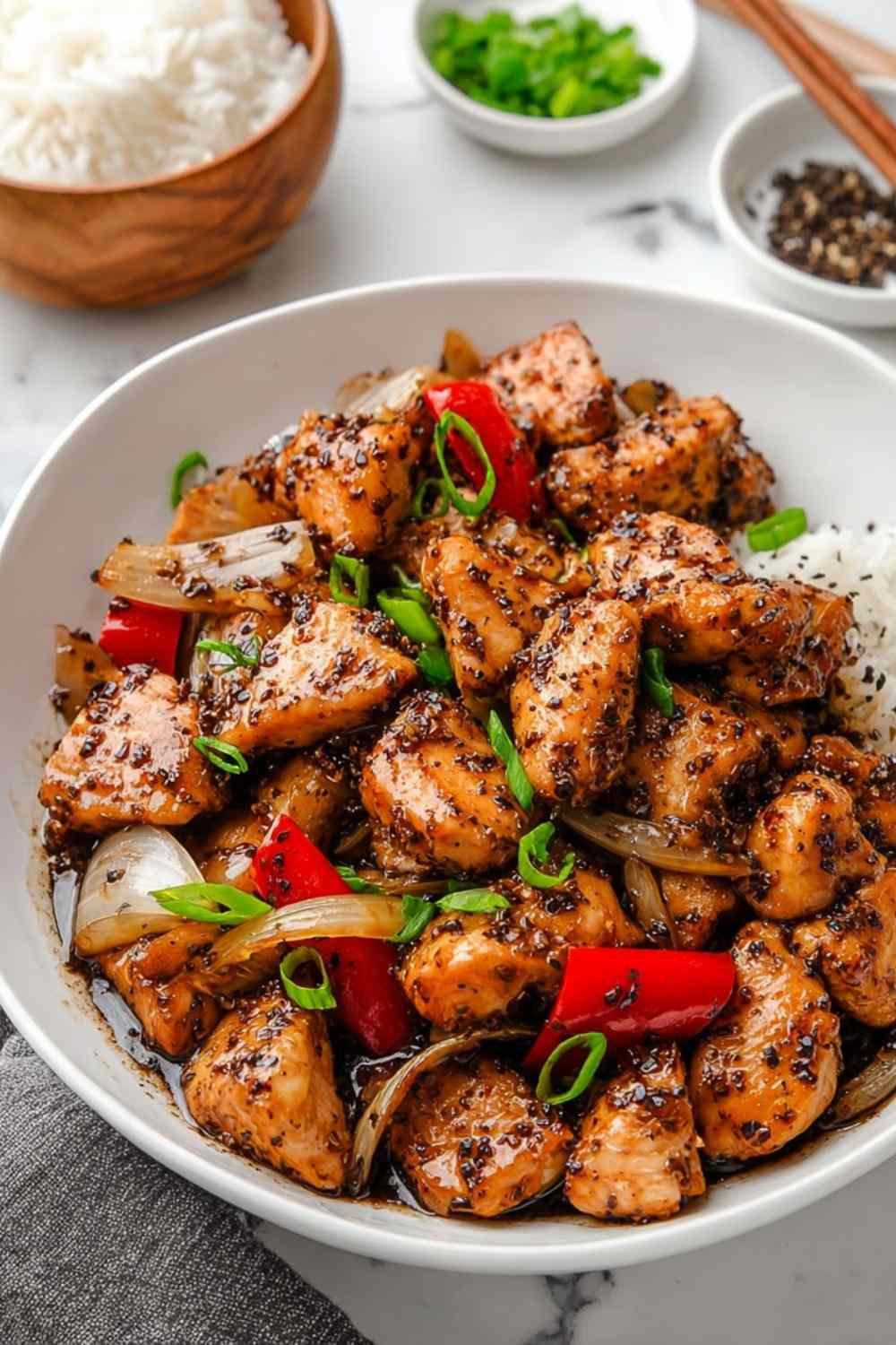 Black Pepper Chicken with crisp bell peppers and onions in a glossy black pepper sauce served over steamed white rice