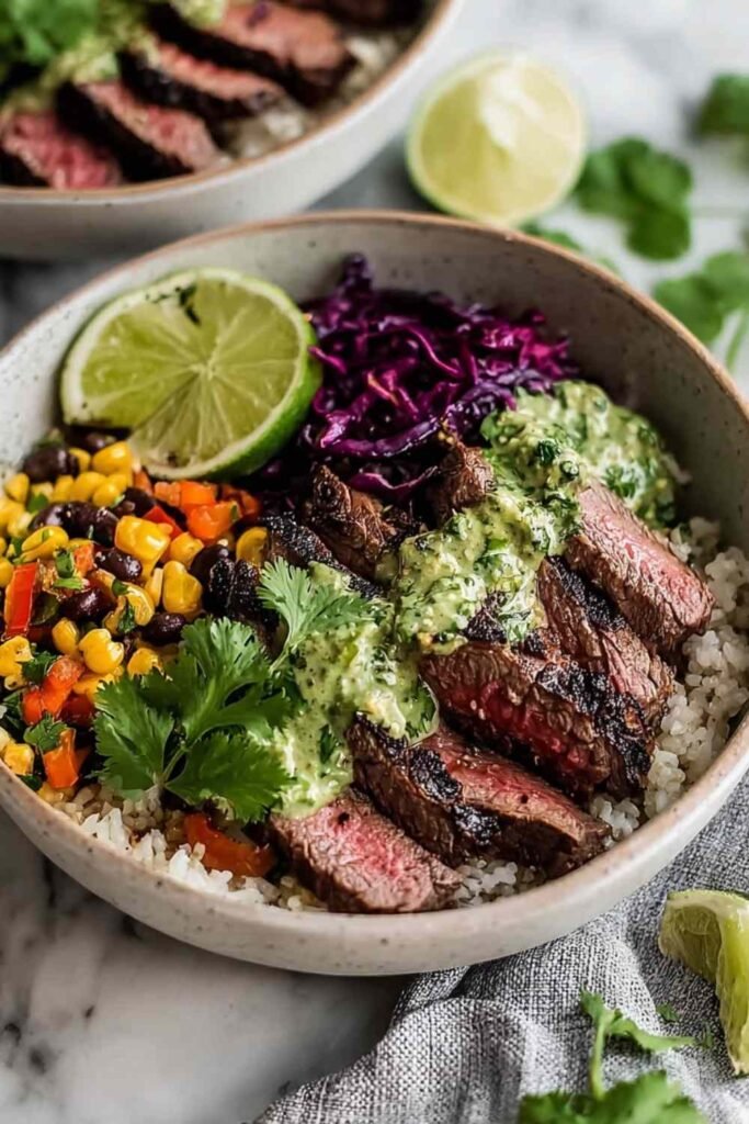 Cilantro lime steak bowls with sliced flank steak rice black beans corn avocado and fresh toppings