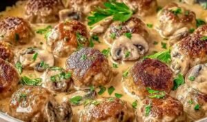 Creamy mushroom chicken meatballs in a skillet with garlic mushroom cream sauce and fresh parsley