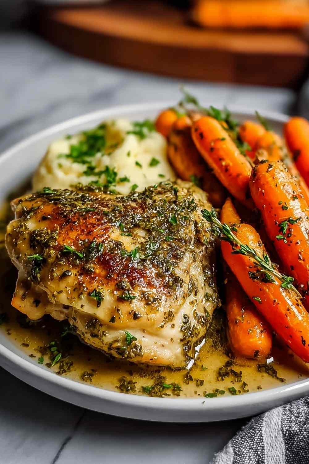 Garlic herb chicken and carrot plate served hot with fresh parsley garnish