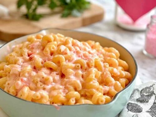 Pink mac and cheese in white bowl naturally colored with beet juice for kid-friendly weeknight dinner