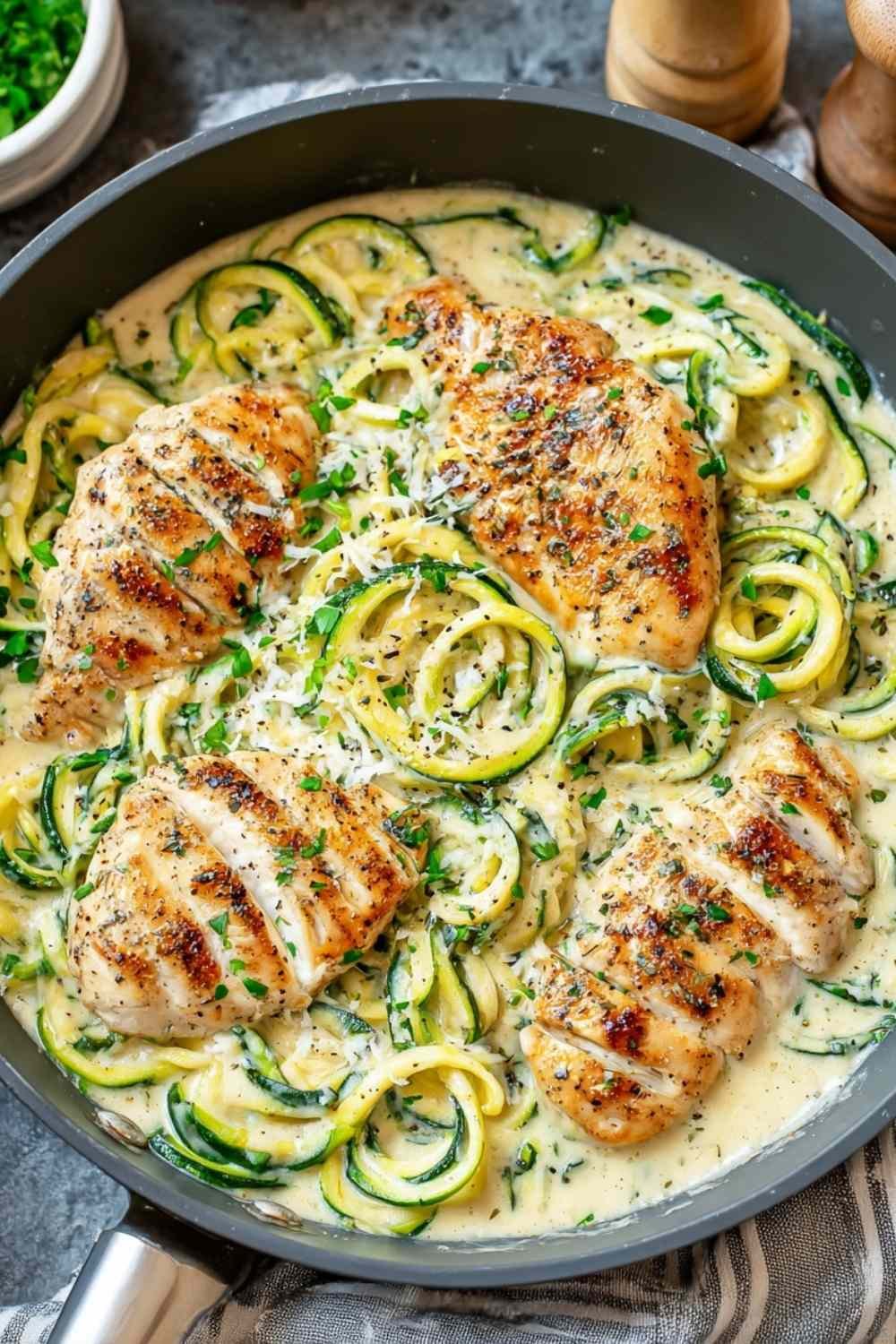 Keto chicken and broccoli casserole in white baking dish with golden melted cheese topping and bubbly edges