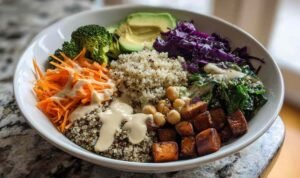 Vegan Buddha Bowl Colorful vegan buddha bowl with quinoa chickpeas roasted sweet potatoes and tahini dressing for healthy plant-based meal