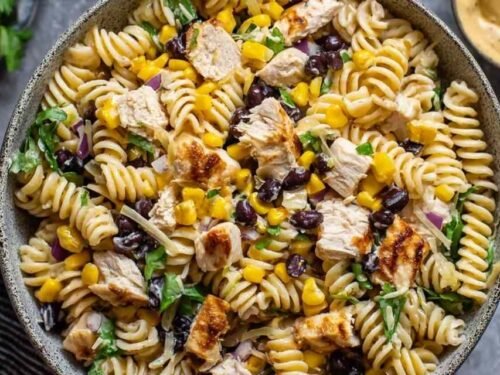 Overhead shot of BBQ Chicken Pasta Salad with shredded chicken, black beans, corn, and creamy BBQ dressing in a large white bowl