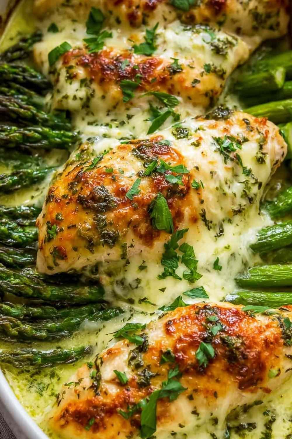 Creamy baked chicken and asparagus in a garlic Parmesan cream sauce in a white baking dish