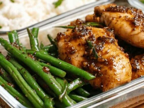 Chicken breast and green beans tossed in honey-soy sauce served over white rice in a bowl
