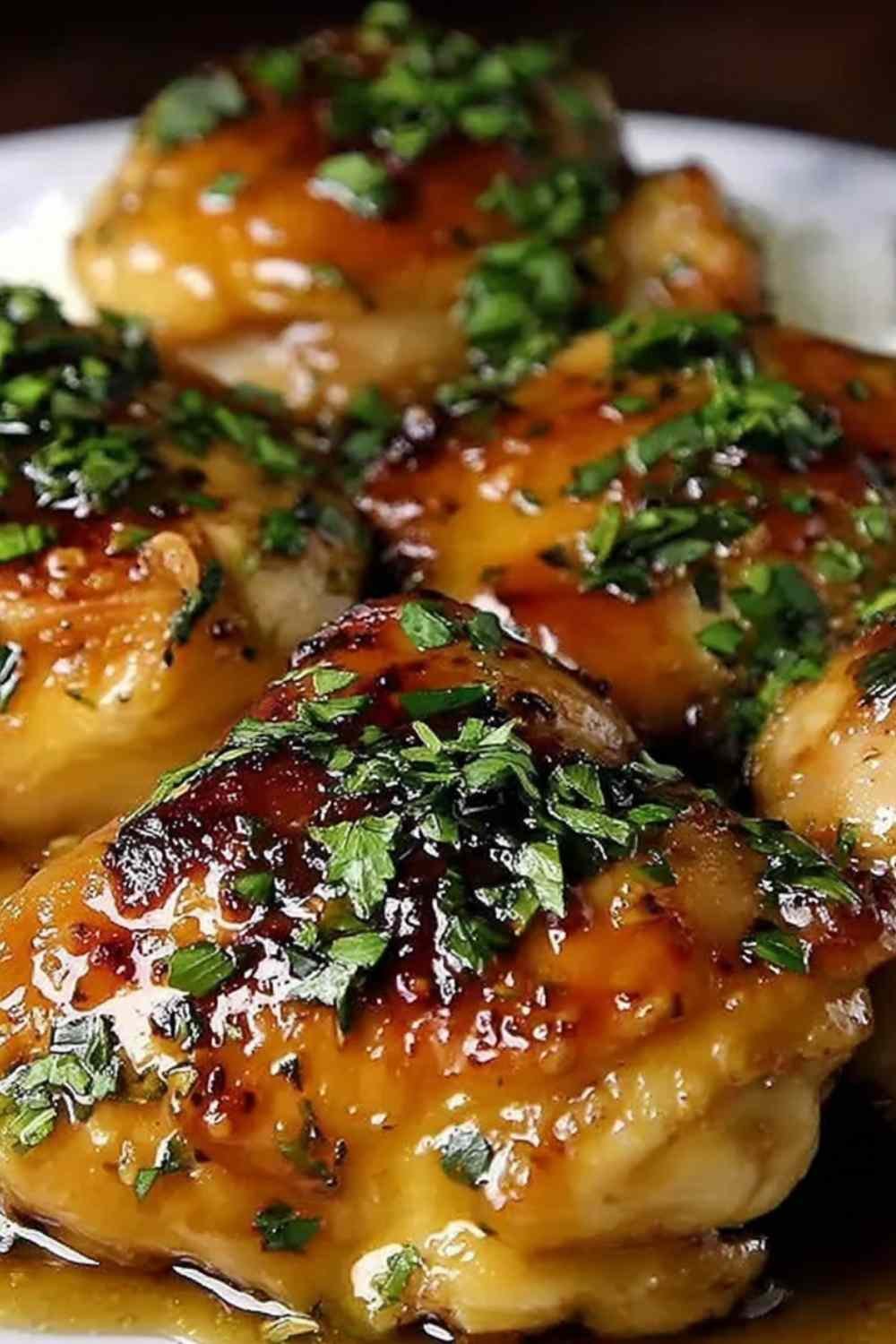 Creamy garlic chicken thighs in a rich lemon garlic cream sauce served over fluffy mashed potatoes in a skillet