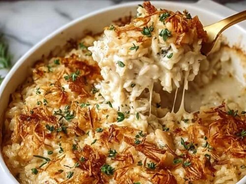 French onion chicken rice bake in a 9x13 baking dish with golden crispy onion topping and melted cheese