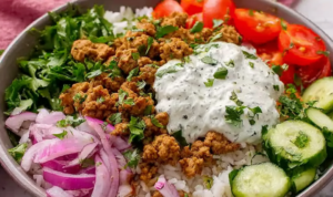 Mediterranean ground turkey bowls with jasmine rice cucumber tomatoes red onion parsley and lemon dill yogurt sauce overhead