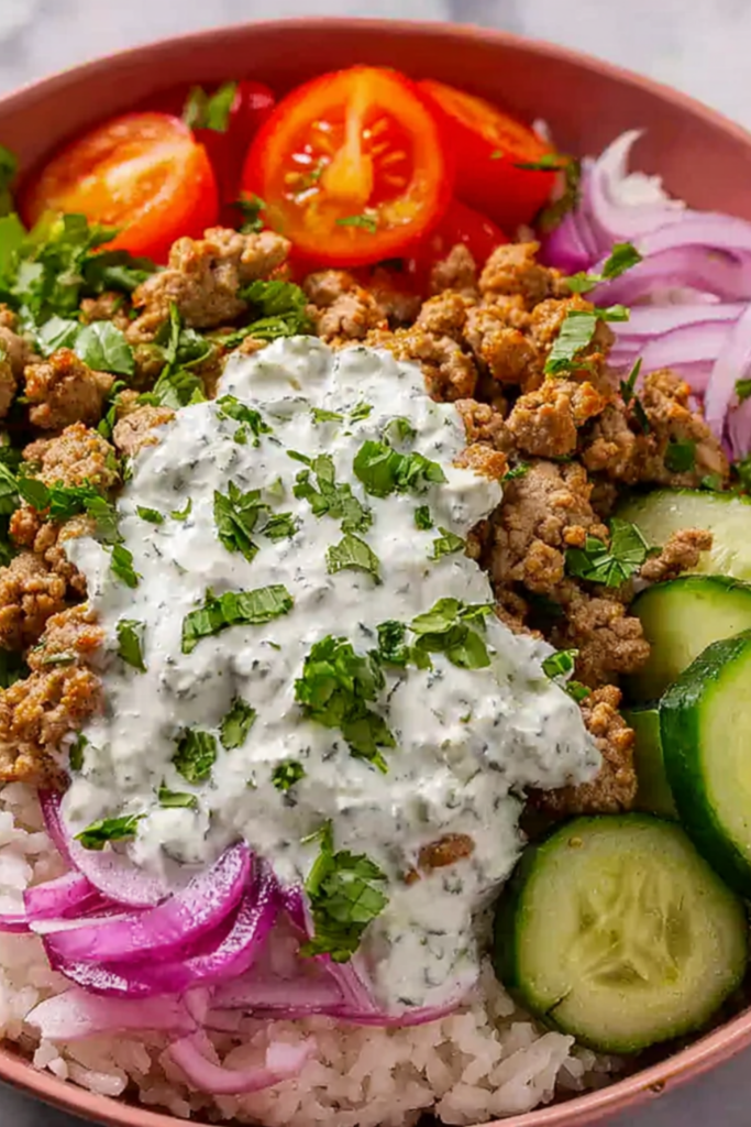 Mediterranean ground turkey bowls with jasmine rice cucumber tomatoes red onion parsley and lemon dill yogurt sauce overhead