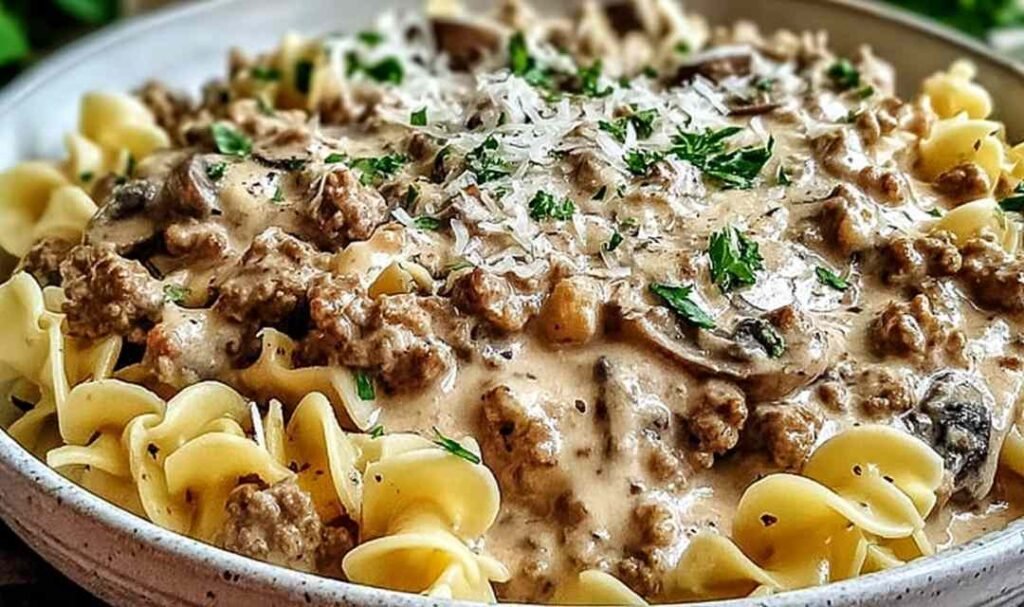 Ground turkey stroganoff in a large skillet with creamy mushroom sauce coating egg noodles and topped with fresh parsley