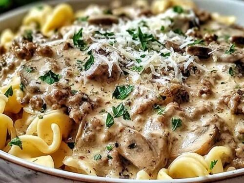 Ground turkey stroganoff in a large skillet with creamy mushroom sauce coating egg noodles and topped with fresh parsley