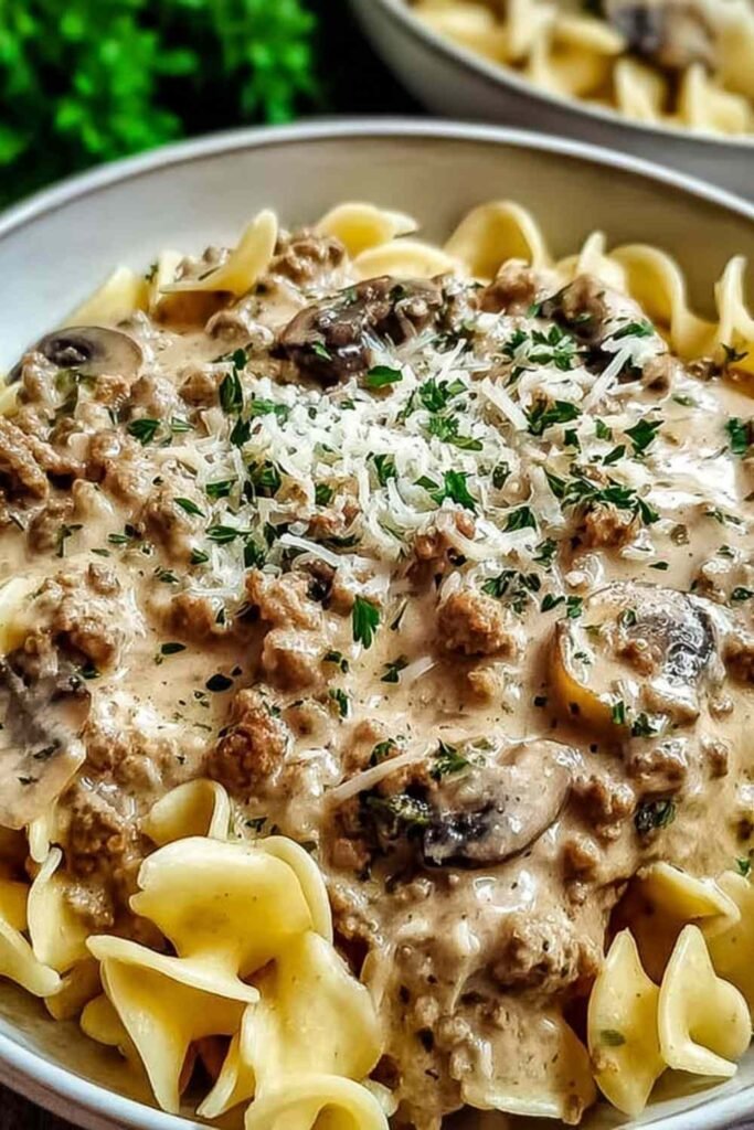 Ground turkey stroganoff in a large skillet with creamy mushroom sauce coating egg noodles and topped with fresh parsley