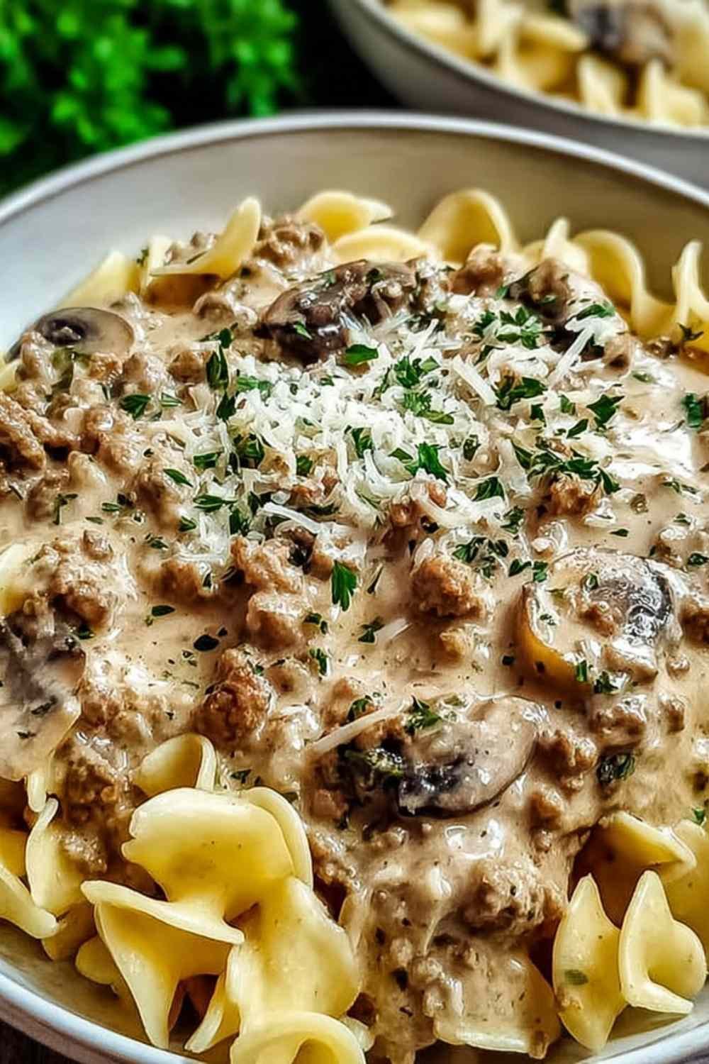 Ground turkey stroganoff in a large skillet with creamy mushroom sauce coating egg noodles and topped with fresh parsley