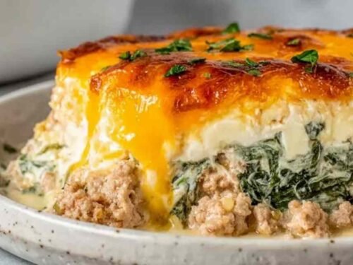 High Protein Ground Turkey Casserole with golden melted cheddar cheese baked in a white 9x9 baking dish