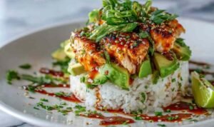 Honey Lime Chicken Avocado Rice Stack Honey Lime Chicken Avocado Rice Stack in a white bowl with grilled chicken strips, avocado slices, black beans, corn, cilantro, and honey lime dressing