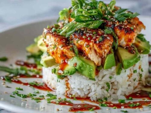 Honey Lime Chicken Avocado Rice Stack in a white bowl with grilled chicken strips, avocado slices, black beans, corn, cilantro, and honey lime dressing