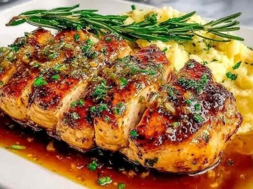 Morton's Chicken Christopher served on a white plate with silky garlic butter cream sauce and fresh parsley