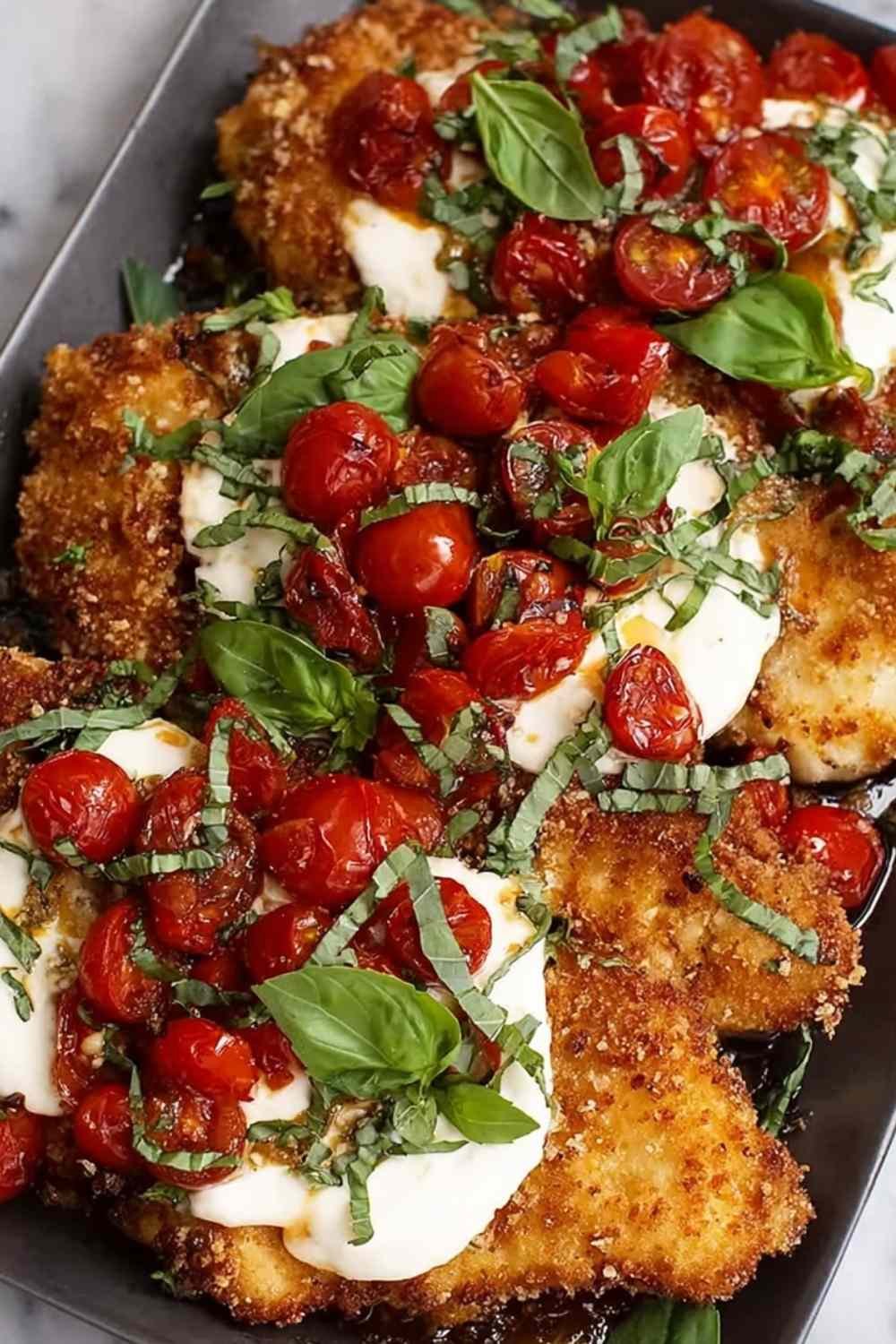 Crispy parmesan basil chicken cutlets golden brown on a white plate with fresh basil garnish