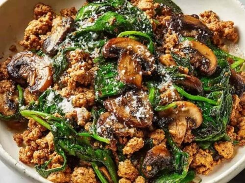 Turkey spinach mushroom skillet in a large pan with ground turkey, wilted spinach, mushrooms, and creamy Parmesan sauce